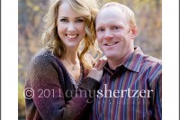 A beautiful mother and father pose for a portrait.