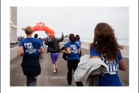 A victorious team runs toward the finish line of Ragnar SoCal 2012.