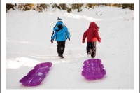 Sledding in the snow.